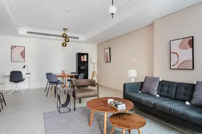 a living room with a couch and a table at Blueground JLT lake view roof pool gym DXB-1546 in Dubai