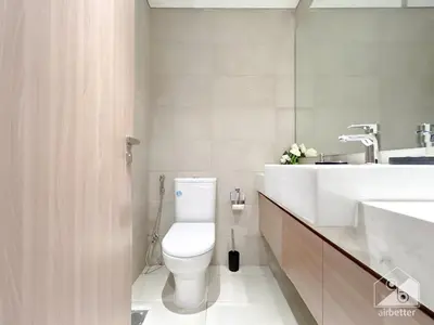 a white bathroom with a toilet and a sink at Charming Studio with Balcony in Azizi Riviera in Dubai