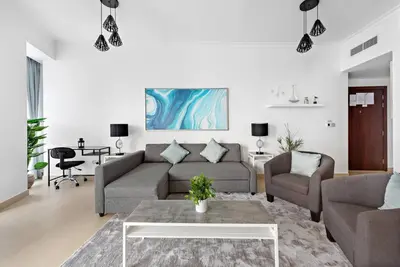 a living room with a couch and a table at Skyline Views 2BR Near Burj Khalifa & Dubai Mall with Pool Access in Dubai