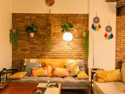 a living room with a couch with colorful pillows at Al Barsha South Fourth in Dubai