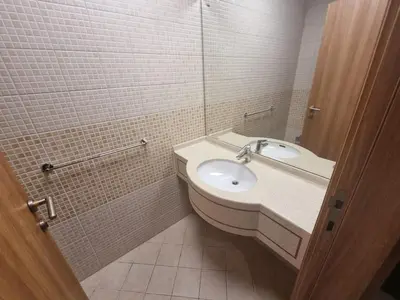 a bathroom with a sink and a mirror at Al Barsha South Fourth in Dubai
