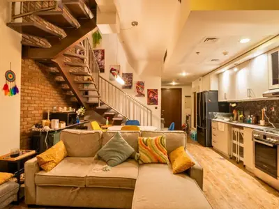 a living room with a couch and a staircase at Al Barsha South Fourth in Dubai
