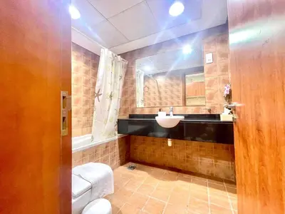 a bathroom with a toilet and a sink at Amazing Studio Apartment in The Crescent A Tower IMPZ in Dubai