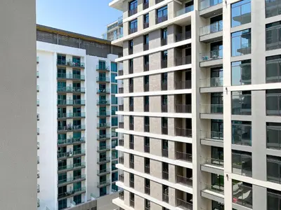 an apartment building with balconies on the side at Wilton Terrace Charm- Stylish 1-Bedroom in MBR City With a Pool View in Dubai