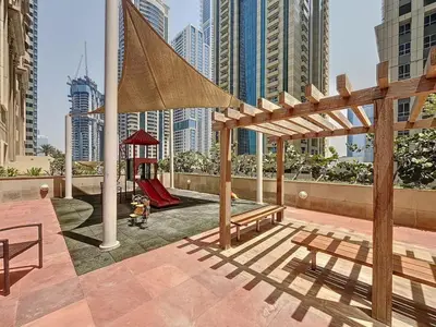 a playground in a city with tall buildings at Elite Residence - Cosy One Bedroom Apartment in Dubai