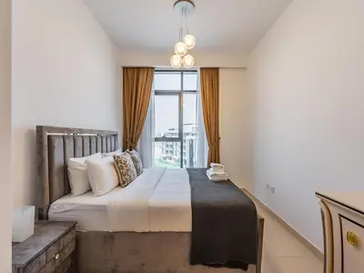 a bedroom with a large bed with a large window at Luxury Meydan Escape Condo with City Views in Dubai