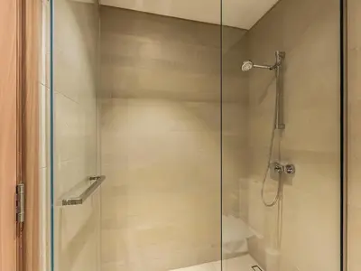 a shower with a glass door in a bathroom at Luxury Meydan Escape Condo with City Views in Dubai