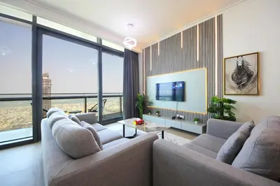 a living room with two couches and large windows at Burj Vista Downtown Near To Dubai Mall - 2BHK in Dubai