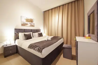 a bedroom with a large bed in a room at Burj Vista Downtown Near To Dubai Mall - 2BHK in Dubai