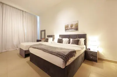 a bedroom with a large bed in a hotel room at Burj Vista Downtown Near To Dubai Mall - 2BHK in Dubai