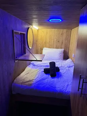 a bed in a room with a blue light at Capsule Room in Business Bay Near Downtown in Dubai