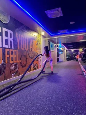 a girl playing with a rope in a bowling alley at Capsule Room in Business Bay Near Downtown in Dubai