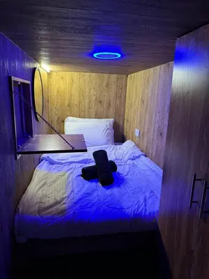 a bed in a room with a blue light at Capsule Room in Business Bay Near Downtown in Dubai