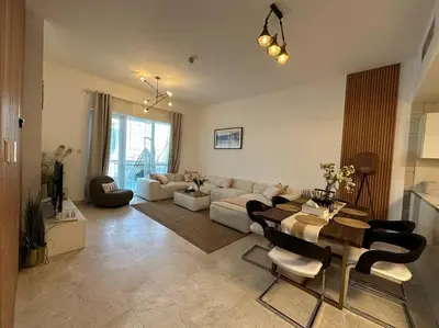 a living room with a couch and a table at Cozy 2BHK with Marina Views in Dubai