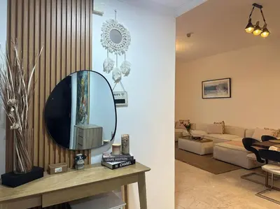 a living room with a mirror on a table at Cozy 2BHK with Marina Views in Dubai