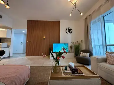 a living room with a couch and a table at Cozy 2BHK with Marina Views in Dubai