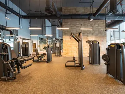 a gym with rows of treadmills and machines at Panoramic Downtown & Fountain views from High Floors at Forte by Propigo in Dubai