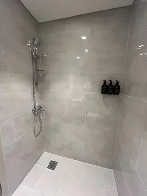 a bathroom with a shower with two bottles on the wall at Panoramic Downtown & Fountain views from High Floors at Forte by Propigo in Dubai