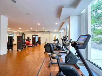 a gym with treadmills and ellipticals in a building at MegaLuxury Flat Resort, Amazing Pool, Burj direct View in Dubai