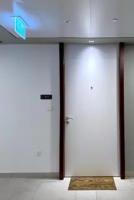 two white doors in a building with a sign on it at MegaLuxury Flat Resort, Amazing Pool, Burj direct View in Dubai