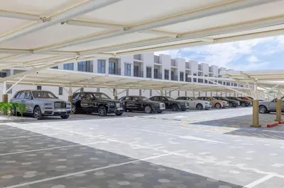 a parking lot with cars parked underneath a building at Sukoon's Elegant Suite in Dubai
