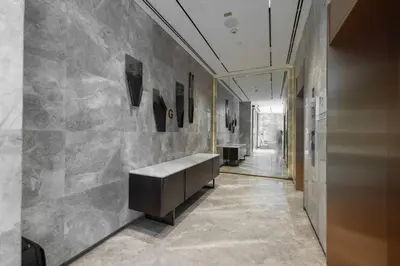 a lobby with a bench in the middle of a hallway at Sukoon's Elegant Suite in Dubai