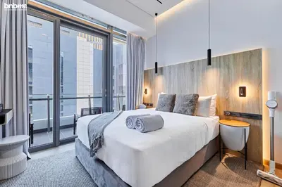 a bedroom with a large bed and a large window at bnbmehomes - Silverene Tower in Dubai