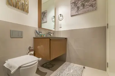 a bathroom with a toilet and a wooden cabinet at Dubai Creek in Dubai