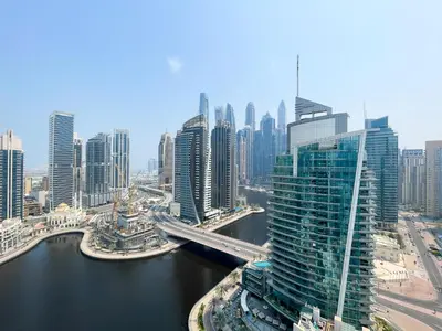 an aerial view of a city with a river and buildings at RH - Marina View Getaway, Spacious One-Bedroom with Terrace in Dubai Marina in Dubai