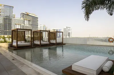 a swimming pool with a resort style poolvisorvisorvisor at Modern Studio at Upside Living, Business Bay with Burj Khalifa View in Dubai