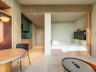 a bedroom with a bed and a table at Modern Studio at Upside Living, Business Bay with Burj Khalifa View in Dubai