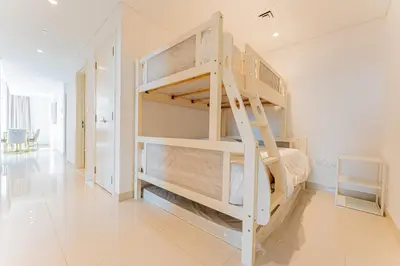 a bunk bed in a room with a staircase at Modern 2BR I Partial Burj Khalifa & Boulevard View in Dubai