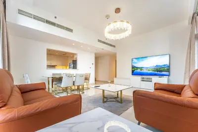 a living room with two couches and a table at Modern 2BR I Partial Burj Khalifa & Boulevard View in Dubai