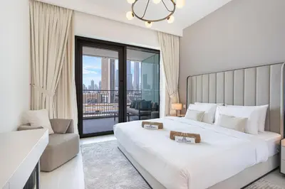 a bedroom with a large bed and a large window at Premium Downtown Home with Burj Khalifa View in Dubai