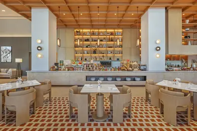a restaurant with tables and chairs and a counter at Vida Dubai Mall in Dubai