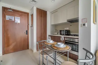 a kitchen with a table with two glasses on it at GuestReady - Stylish living at Reva Residence in Dubai