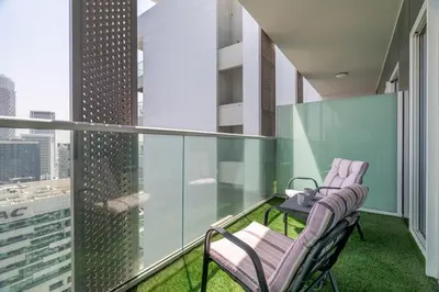 a balcony with two chairs and a table at GuestReady - Stylish living at Reva Residence in Dubai
