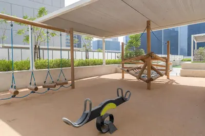 a swing set in a building with a canopy at GuestReady - Stylish living at Reva Residence in Dubai