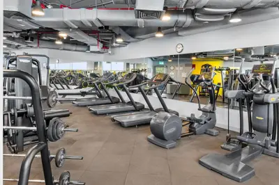 a gym with many rows of tread machines at DIFC Downtown Dubai - Exclusive 1 BR in Dubai