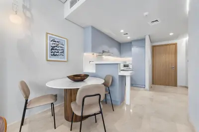 a kitchen and dining room with a table and chairs at DIFC Downtown Dubai - Exclusive 1 BR in Dubai