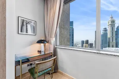 a desk and chair in a room with a window at DIFC Downtown Dubai - Exclusive 1 BR in Dubai