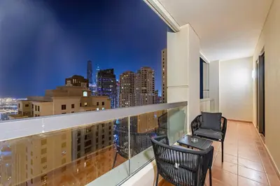 a balcony with a view of a city skyline at Stunning Sea & Palm View 2BR, Steps from JBR Beach & Waterfront in Dubai