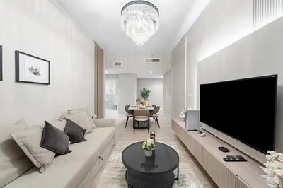 a living room with a large flat screen tv at Stunning Sea & Palm View 2BR, Steps from JBR Beach & Waterfront in Dubai