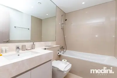 a bathroom with a sink and a tub and a toilet at Prime location - ACT 1 ACT 2 - Downtown in Dubai