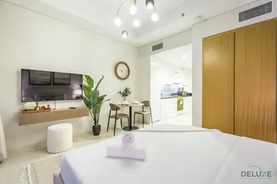a bedroom with a large bed and a kitchen at Special Offer Refined Studio with City Views by Deluxe Holiday Homes in Dubai