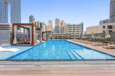 a large swimming pool on top of a building at Lujo Dubai Marina in Dubai