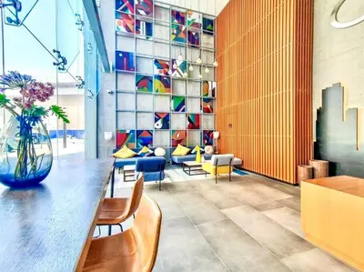 a lobby with a vase of flowers on a table at Lujo Dubai Marina in Dubai