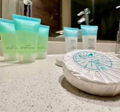 a bathroom counter with a white plate on a sink at Lujo Dubai Marina in Dubai
