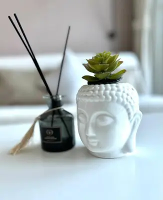 a white mask vase with a plant in it at Lujo Dubai Marina in Dubai