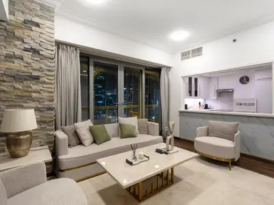 a living room with a couch and a table at Elegant Two Bedroom Apartment with Large Balcony and Panoramic Downtown Skyline & Boulevard Views by Luxury Space in Dubai